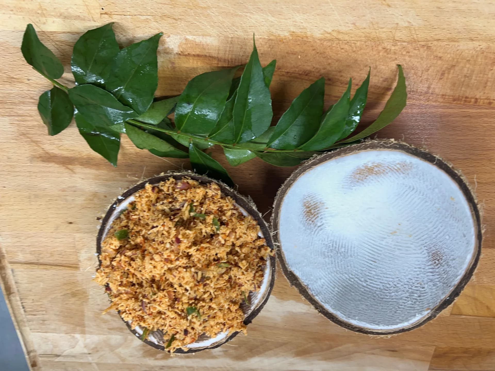 Fresh pol sambol served in coconut shell with curry leaves