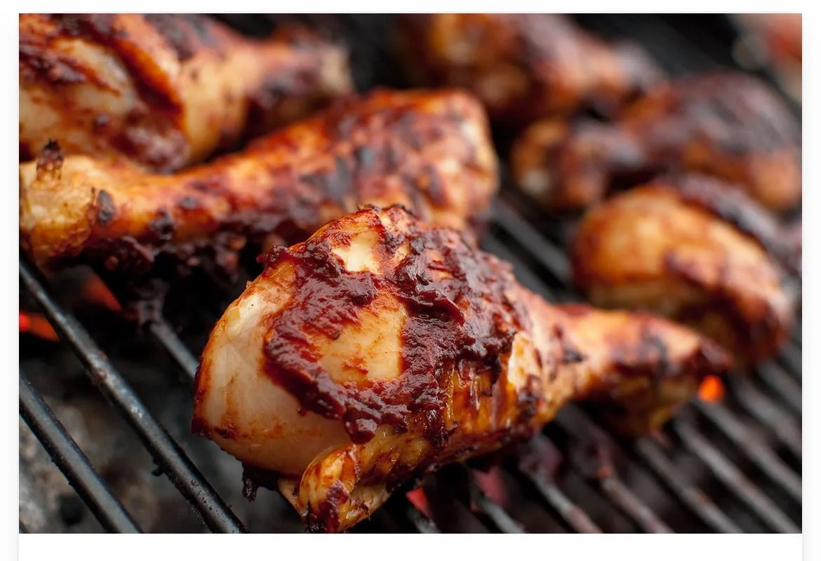 Sri Lankan curry-marinated BBQ chicken with grill marks over open flame