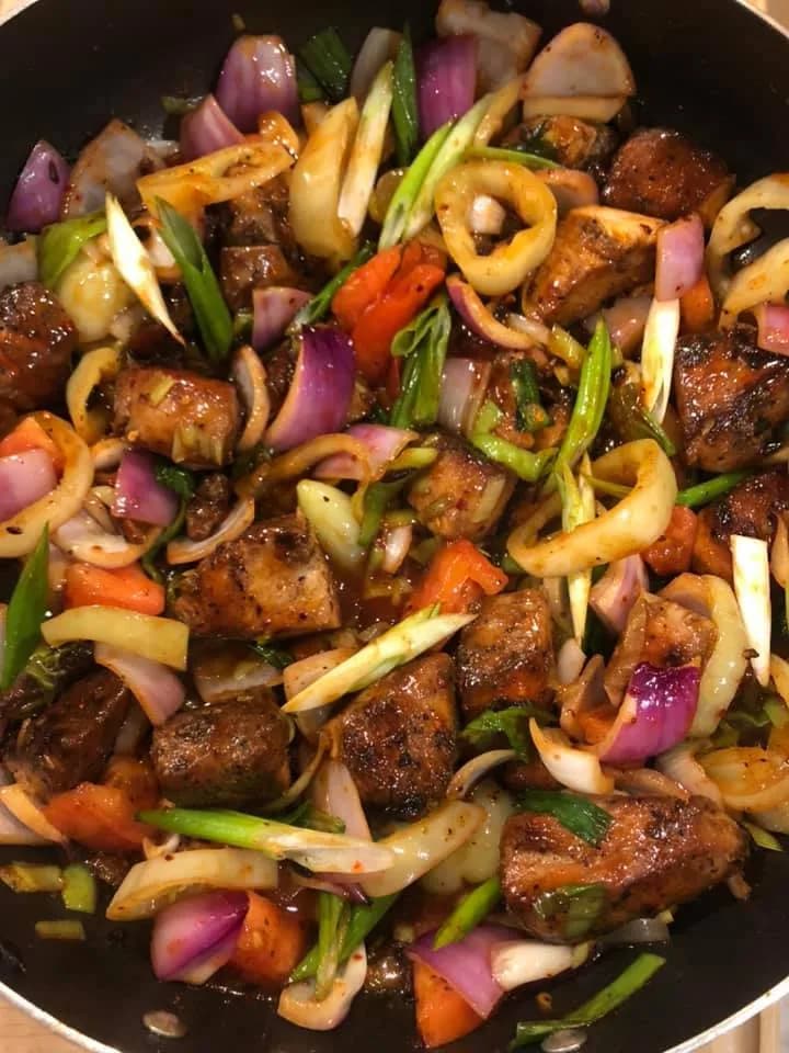 Sri Lankan deviled chicken with vibrant peppers and onions