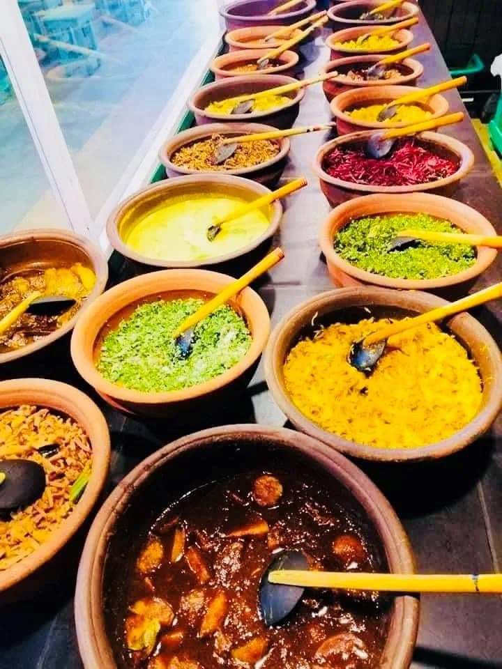 Sri Lankan curry buffet spread with colorful dishes in clay pots for corporate event catering